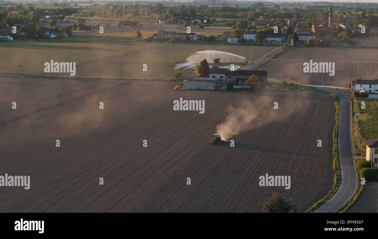 Aerial View Over Italys Po Valley At Sunset Tractor Cultivating Dusty Aerial View Over Italys Po Valley At Sunset Tractor Cultivating Dusty