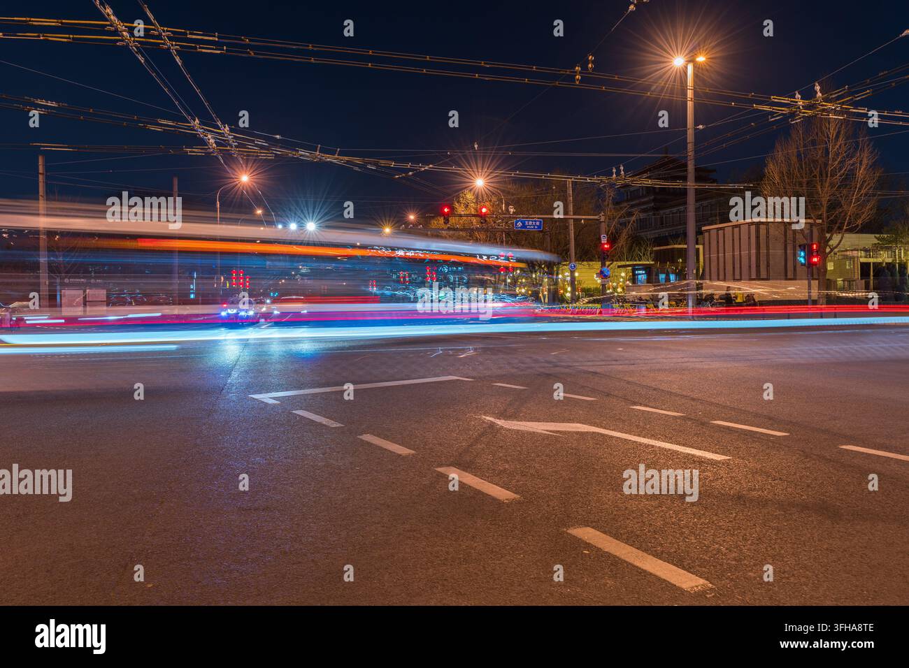 Light trails on busy intersection at night in Beijing Stock Photo
