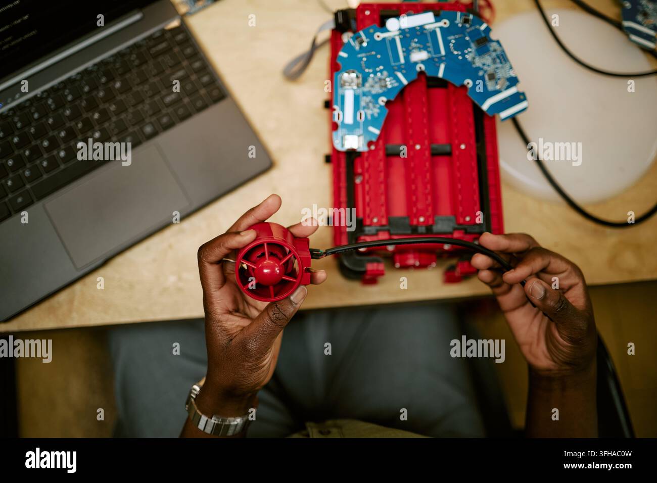 Hands of Black Engineer Assembling Robotic Device in Tech Lab Stock Photo
