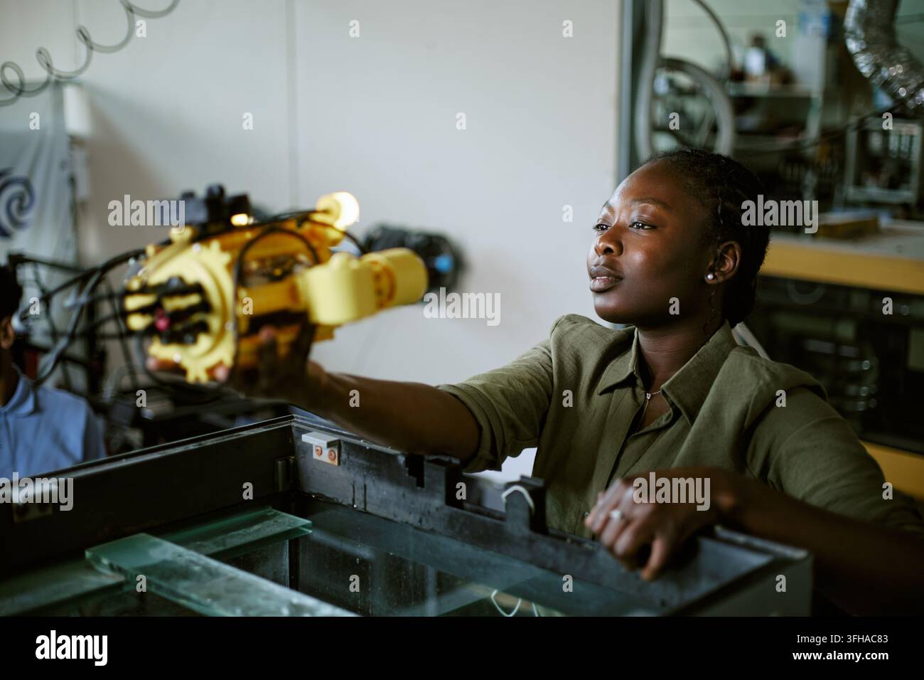 Black Woman Engineer Testing Underwater Robotics Prototype in Lab Stock Photo