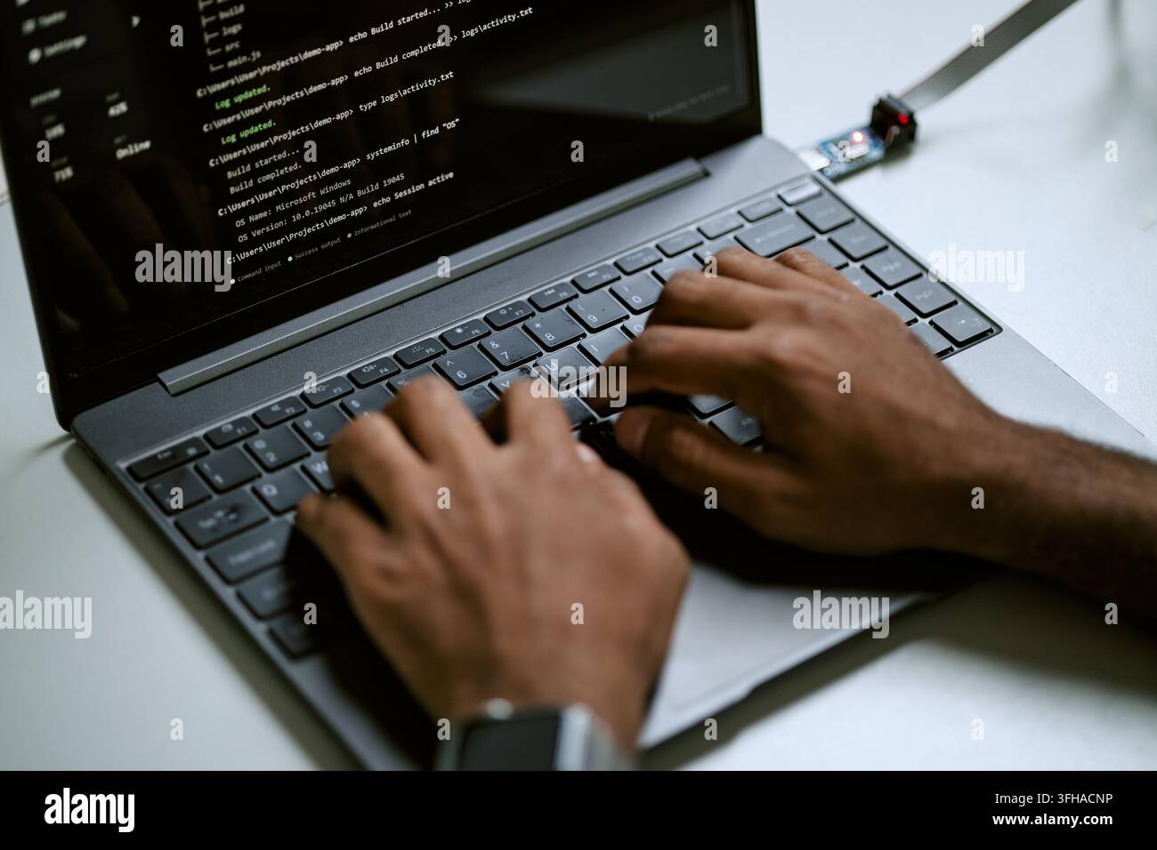 Black Programmer Typing Code on Laptop Keyboard for Software Development Stock Photo