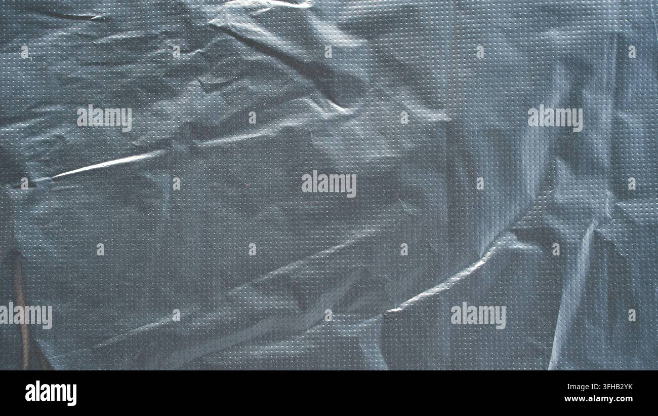 Black plastic bag texture background crumpled polyethylene sheet abstract surface copy space Stock Photo