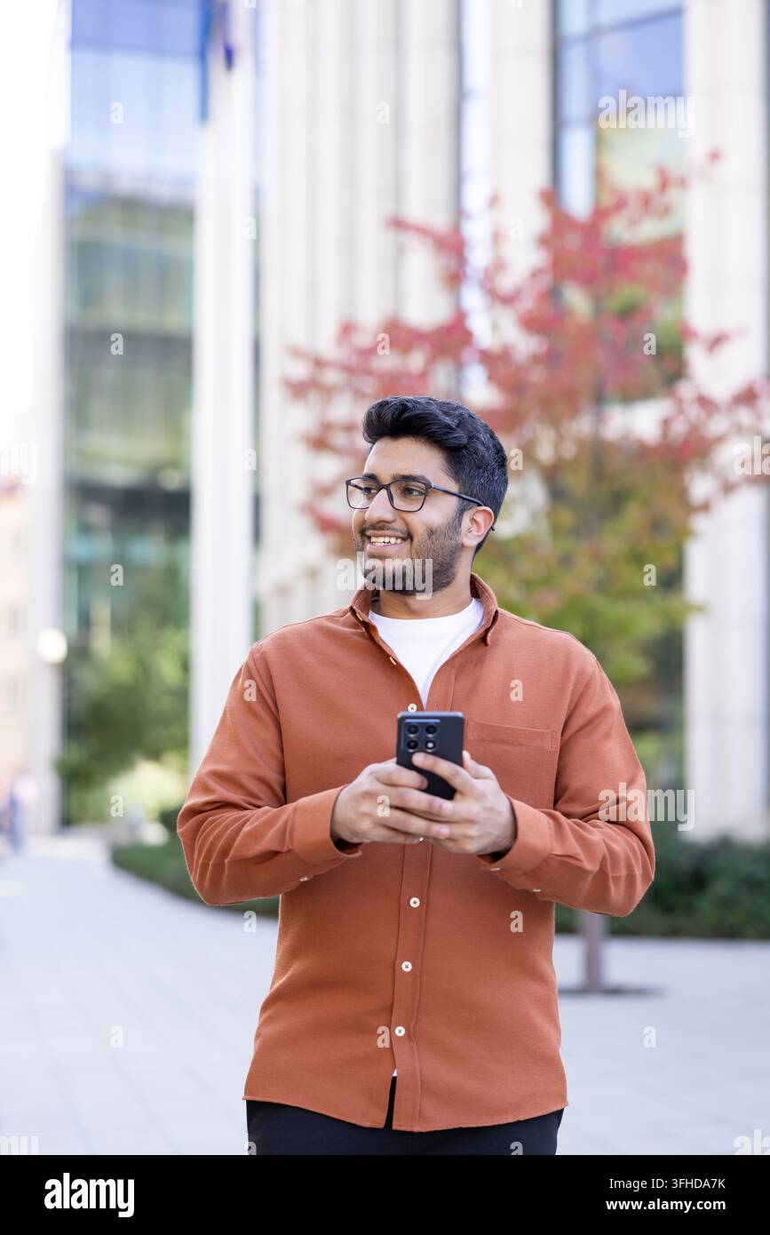 Young man using smartphone for digital communication and mobile technology. Stock Photo