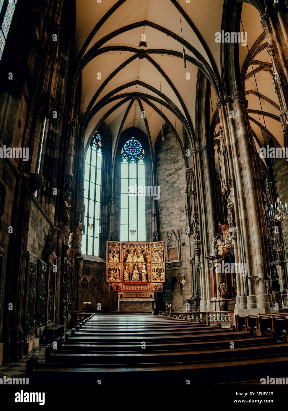 Ornate altar beneath tall stained glass windows hi-res stock ...