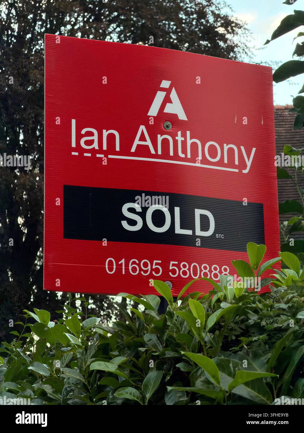 Ian Anthony estate-agent SOLD board outside a Warrington home shows a residential property sale has been agreed. Stock Photo