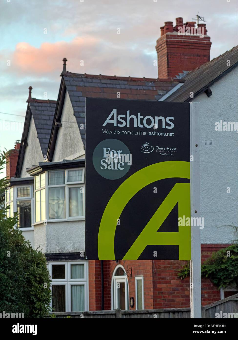 Ashtons For Sale board outside a semi-detached home in Grappenhall, Warrington, illustrating first-time buyer housing affordability. Stock Photo