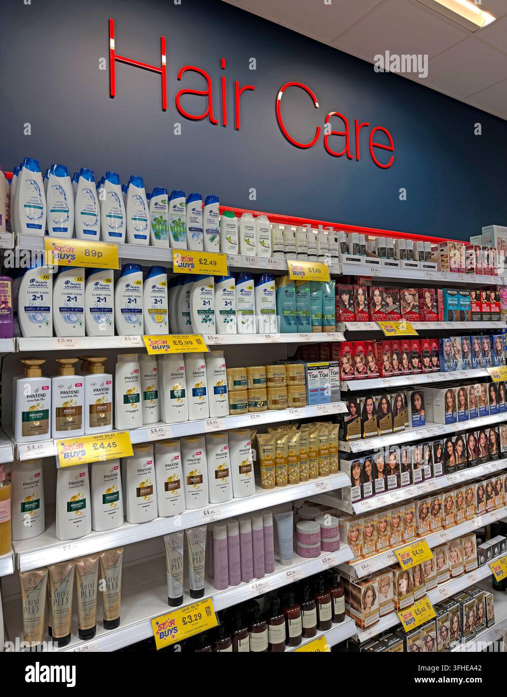 Hair-care shelves in a UK supermarket display shampoos, conditioners and branded products including Pantene. Stock Photo