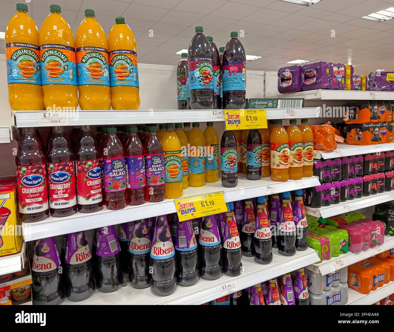 Ribena, Robinsons and other fruit drinks and squash bottles displayed in a UK supermarket drinks aisle. Stock Photo