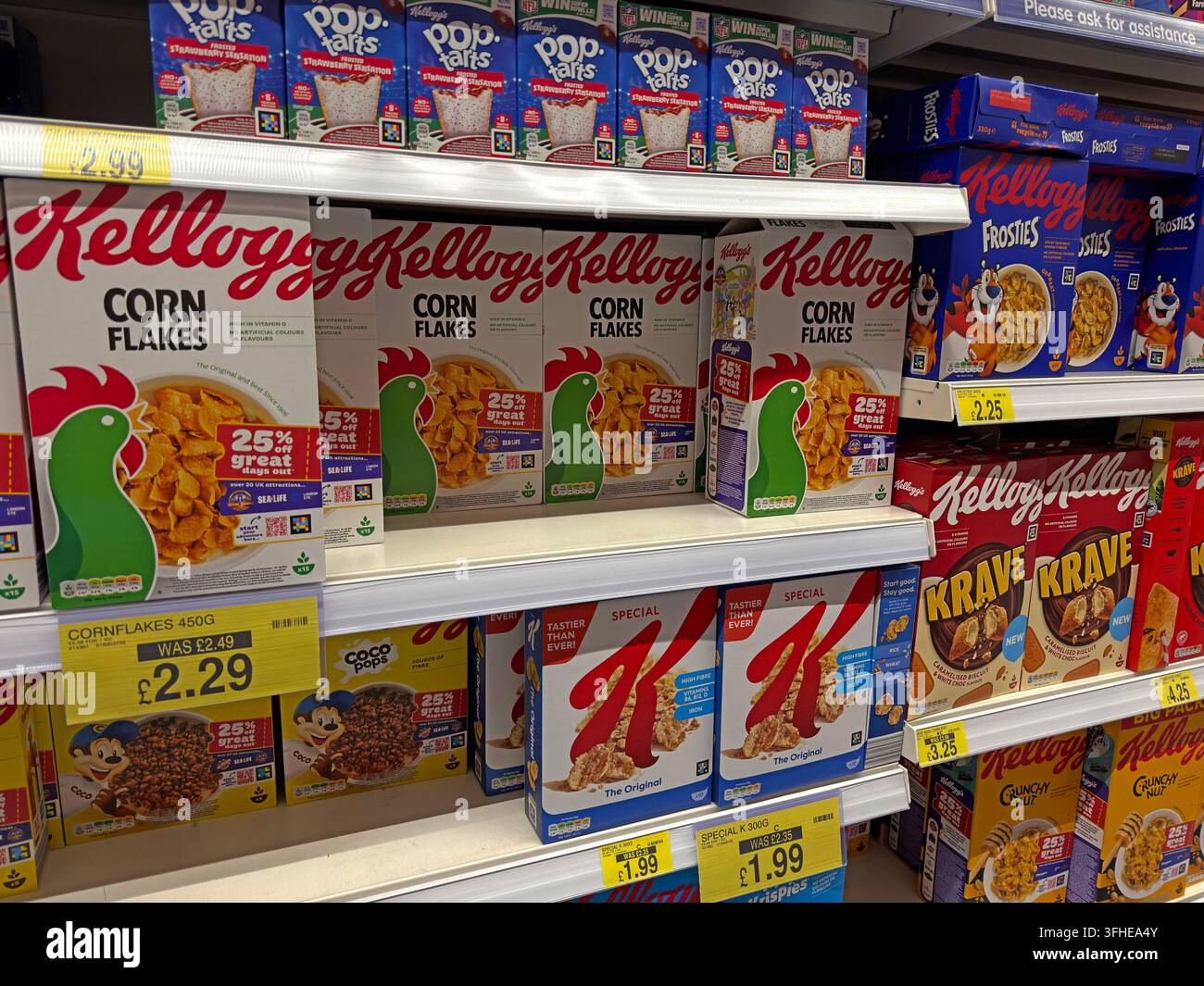 Kellogg's breakfast cereals including Corn Flakes and Krave displayed on shelves in a UK supermarket. Stock Photo