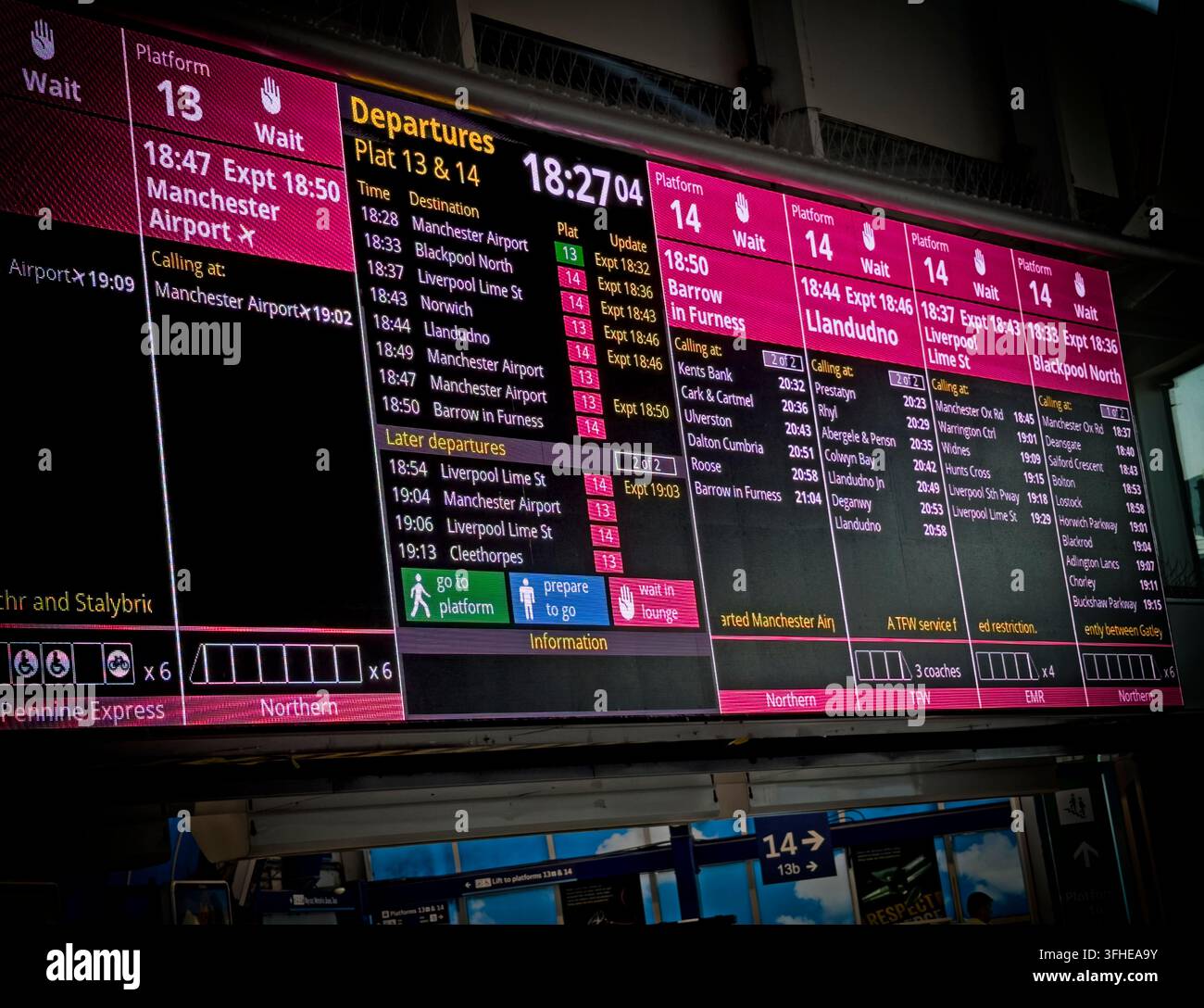 Red delay information on Manchester Piccadilly departure boards for platforms 13 and 14 highlights pressure on the Castlefield rail corridor. Stock Photo