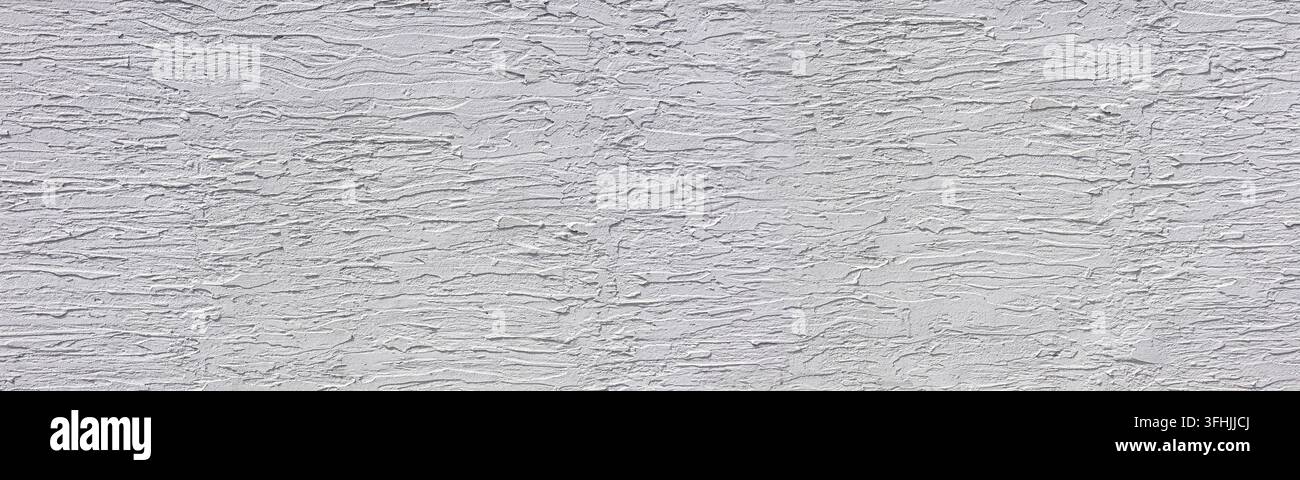 Rough white stucco wall texture creating an abstract textured background Stock Photo
