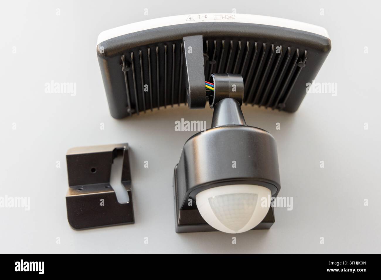 Black and white security light components are shown on a clean white background Stock Photo