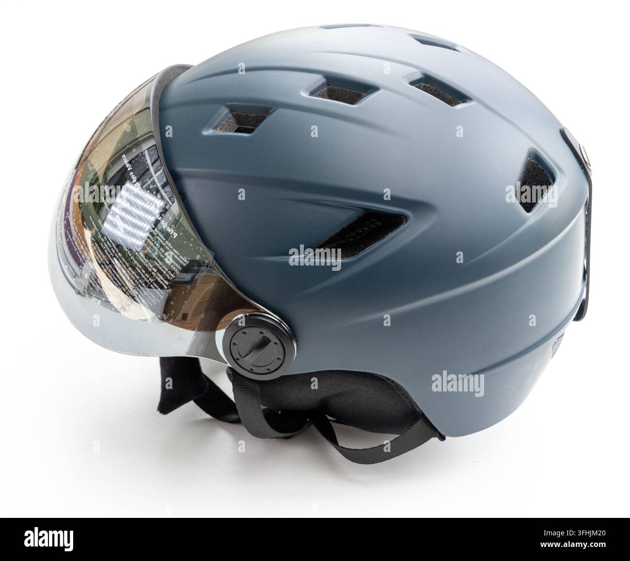 A grey protective helmet with a clear visor is shown Stock Photo