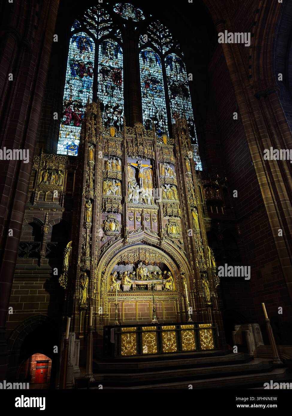 Ornate altar beneath tall stained glass windows hi-res stock ...