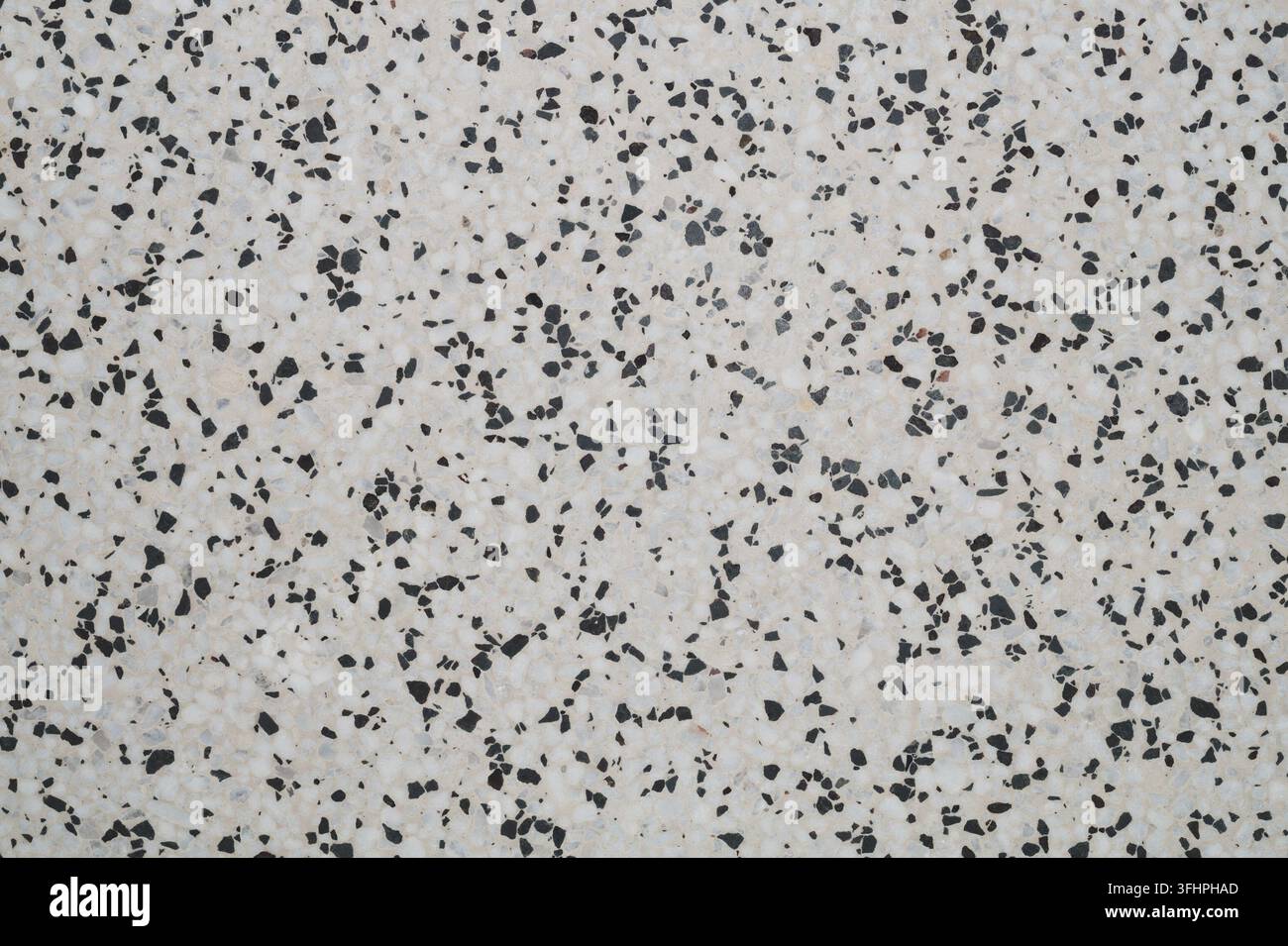 Grey terrazzo texture with dark stone chips Stock Photo