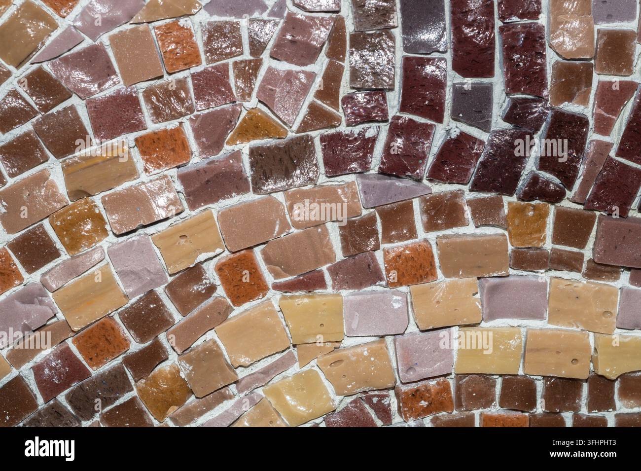 Macro of earthy brown and beige ceramic mosaic tiles with varied shapes Stock Photo