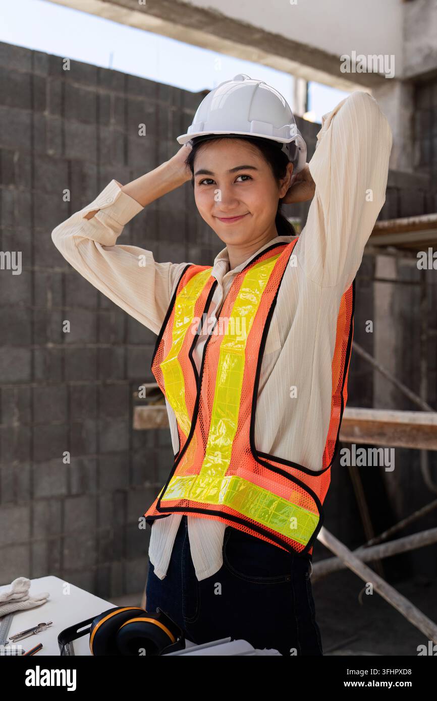 Female construction engineer. Architect with a blueprint at a construction site Stock Photo