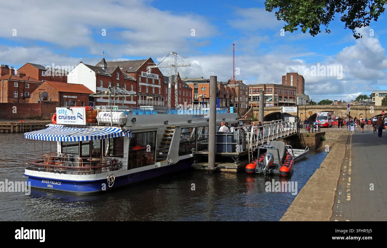 City Cruises by Hornblower sightseeing boat on the River Ouse at King's Staith in York, with historic riverside buildings behind. Stock Photo