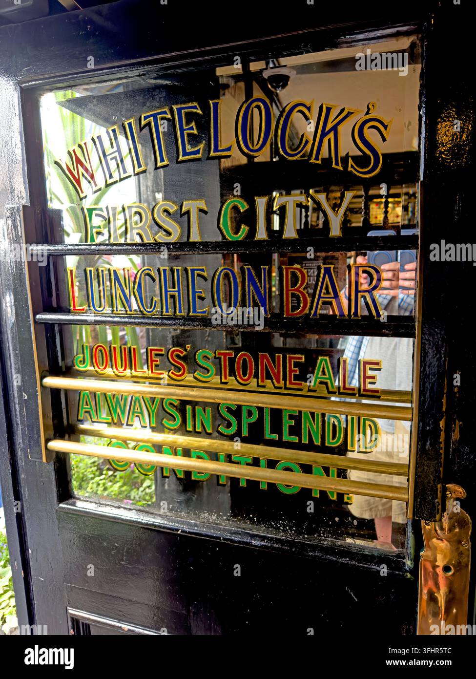 Historic Whitelock's First City Luncheon Bar door and painted glass lettering in Turk's Head Yard, Leeds. Stock Photo
