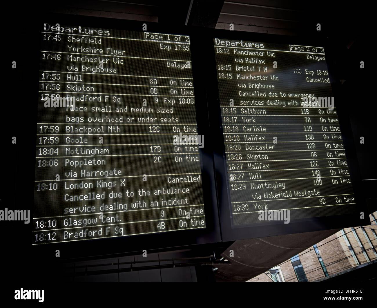Electronic train departure boards at Leeds railway station displaying services, platforms, times and delays. Stock Photo