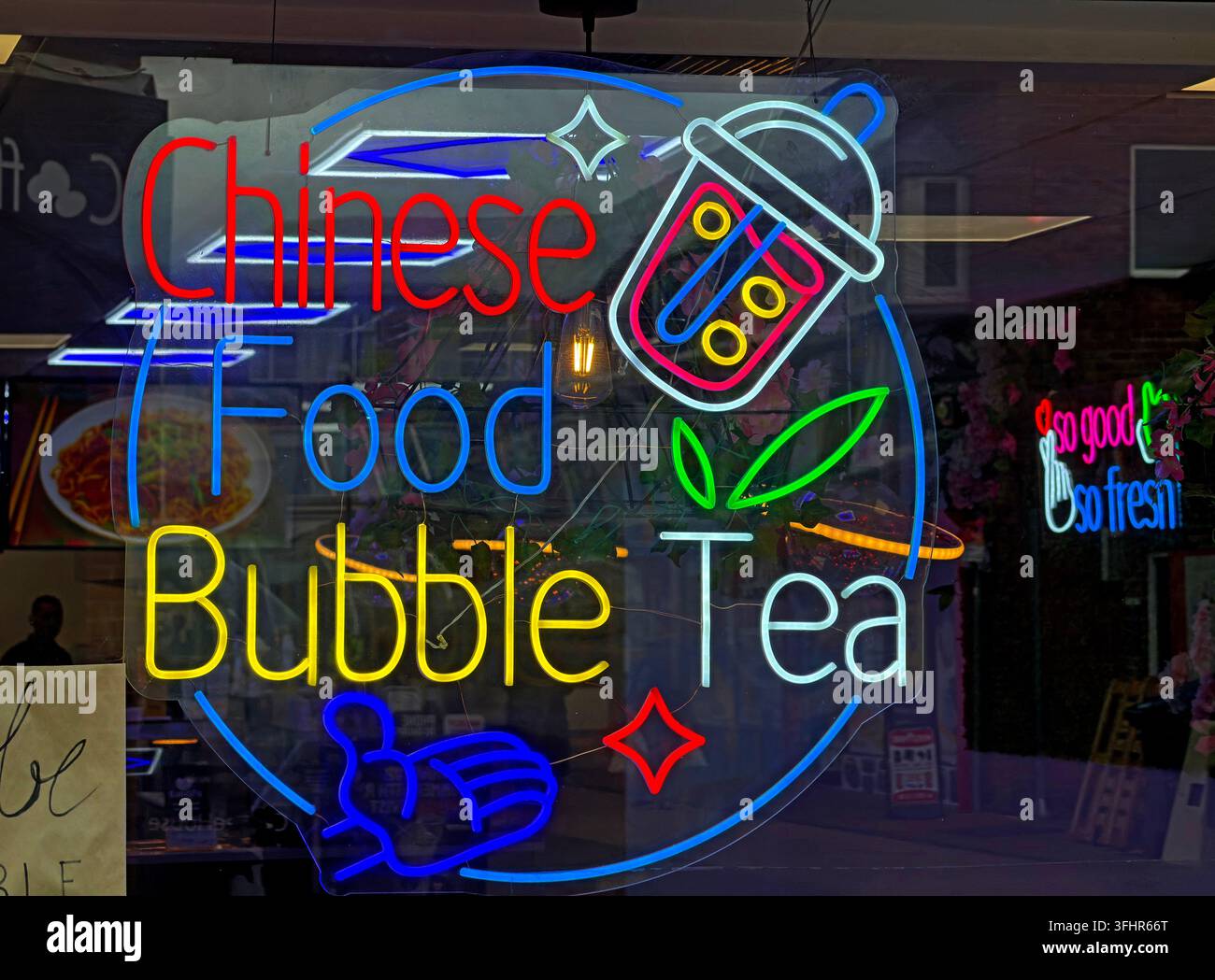 Colourful neon-style Chinese Food and Bubble Tea sign in a Chorley town-centre takeaway window, Lancashire. Stock Photo