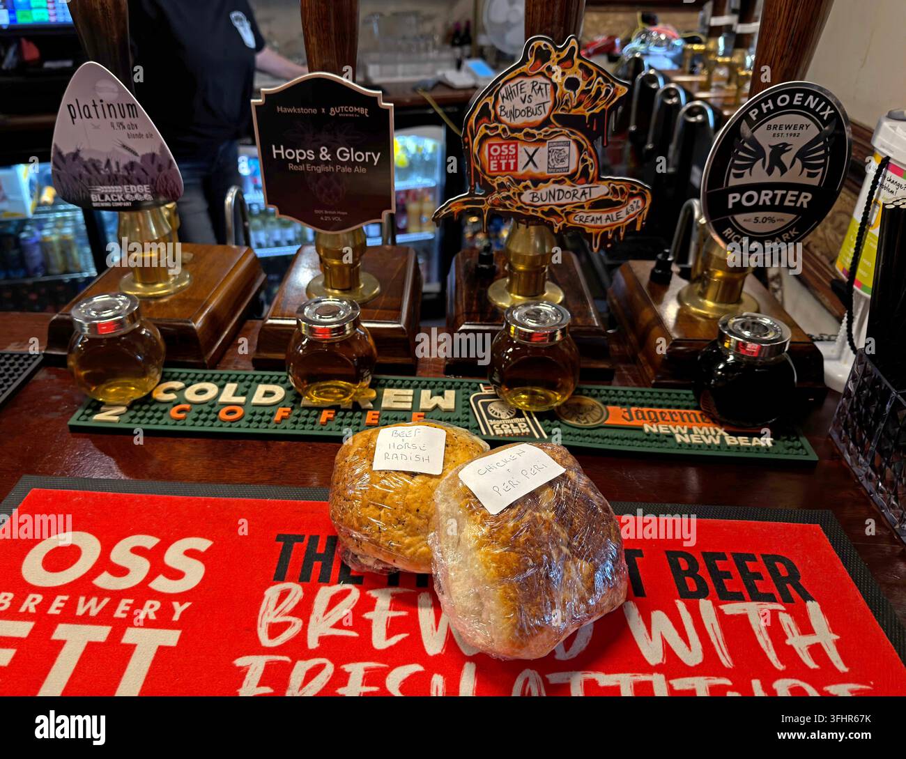 Real ale handpulls and traditional filled pub rolls on the bar at Malt 'n' Hops, Chorley, Lancashire. Stock Photo