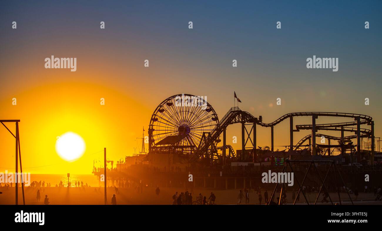 Santa Monica Pier silhouetted at sunset. Golden sunset over Santa ...