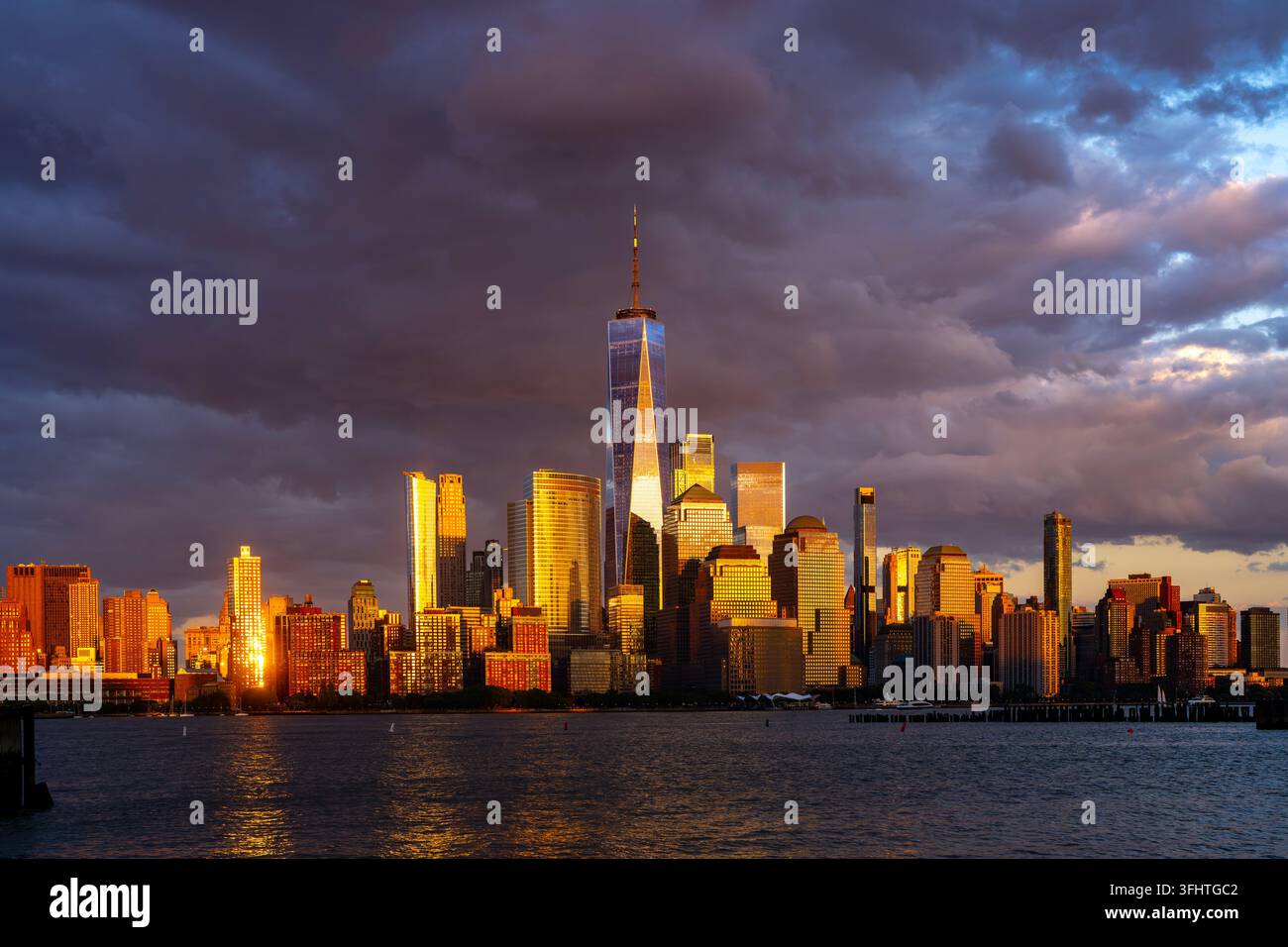 New York skyline with dramatic sky. Golden New York sunset lights ...