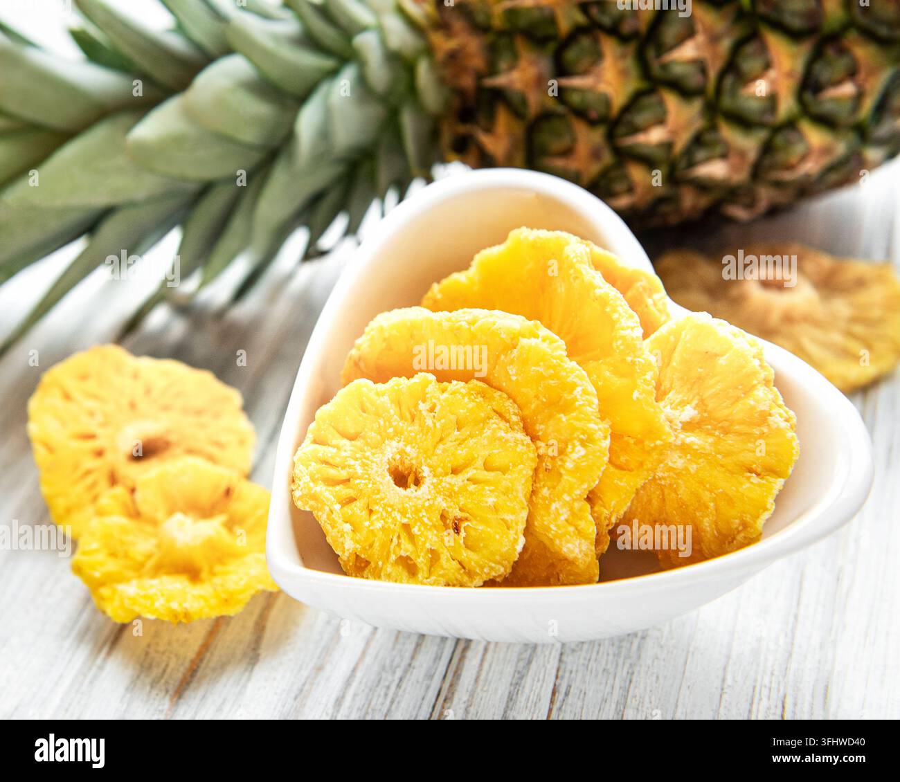 Pineapple dried rings on rustic wooden background Stock Photo