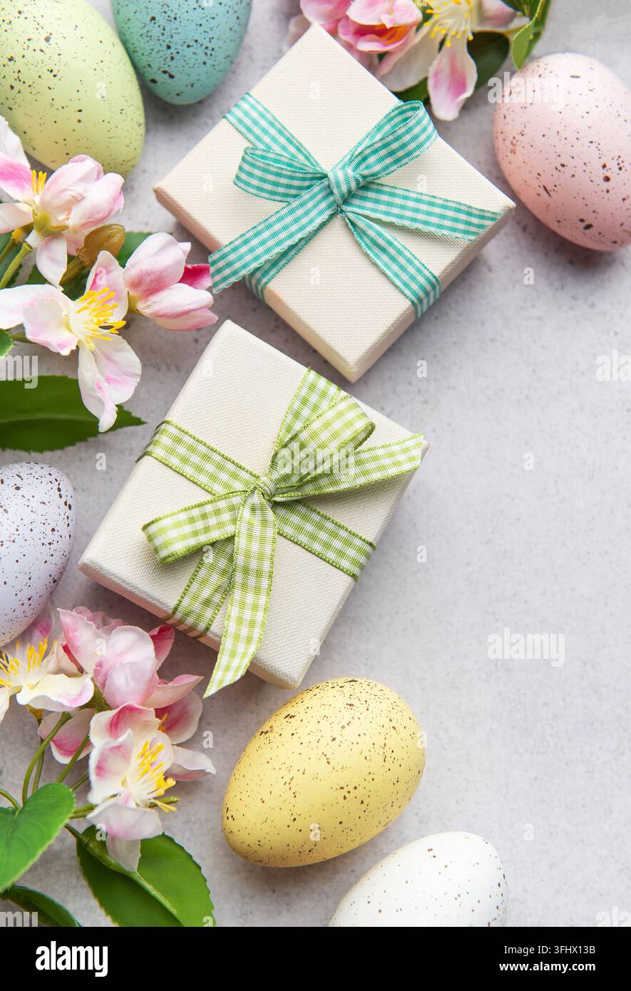 Easter gifts and speckled eggs with spring flowers Stock Photo