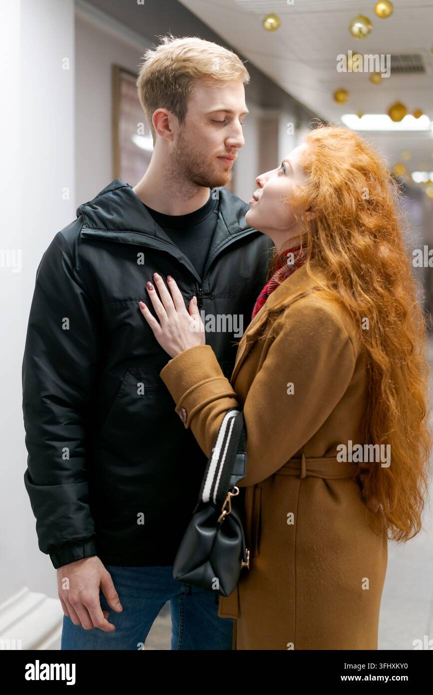 Man and a woman are standing in a hallway Stock Photo