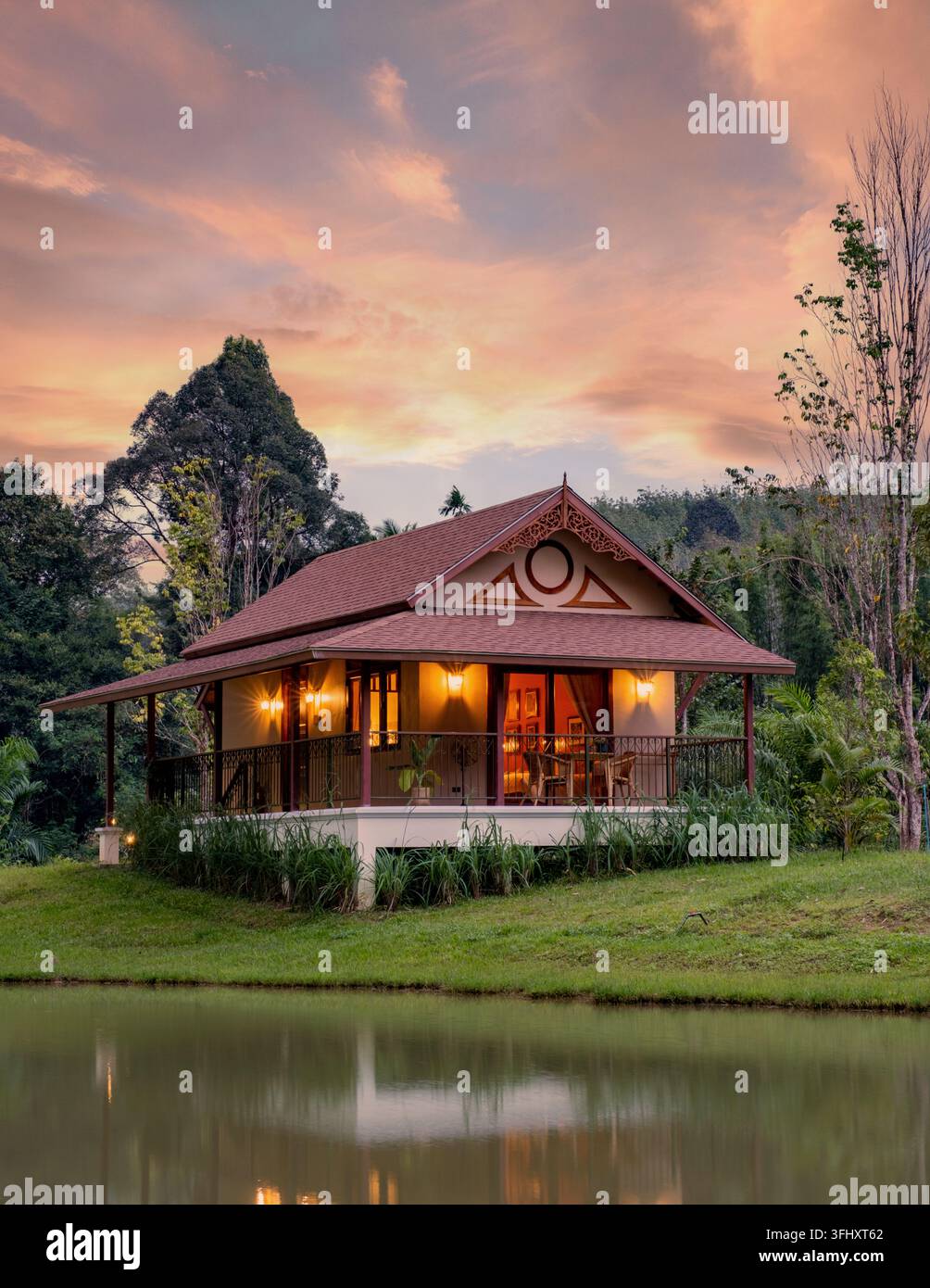 Charming countryside house at sunset in Khao Sok Thailand surrounded by nature Stock Photo
