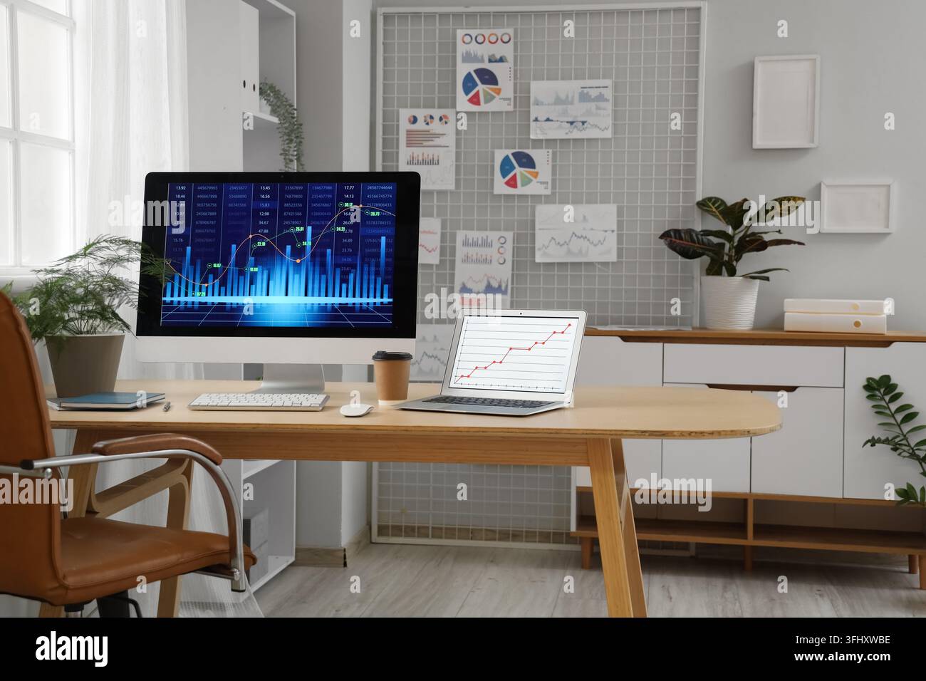 Data scientists workplace with computer and diagrams in office Stock Photo