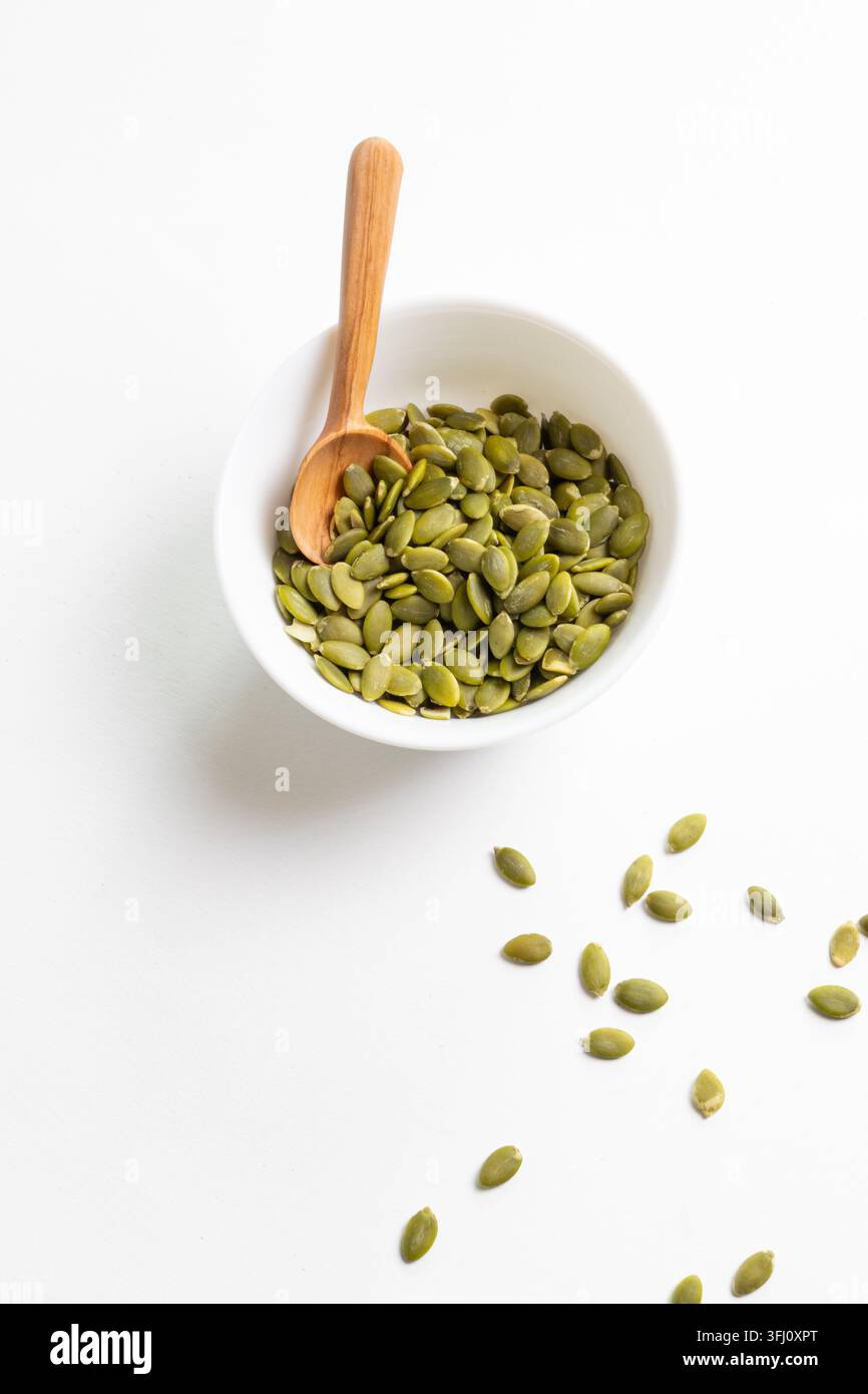 Pumpkin seeds in a white dish Stock Photo