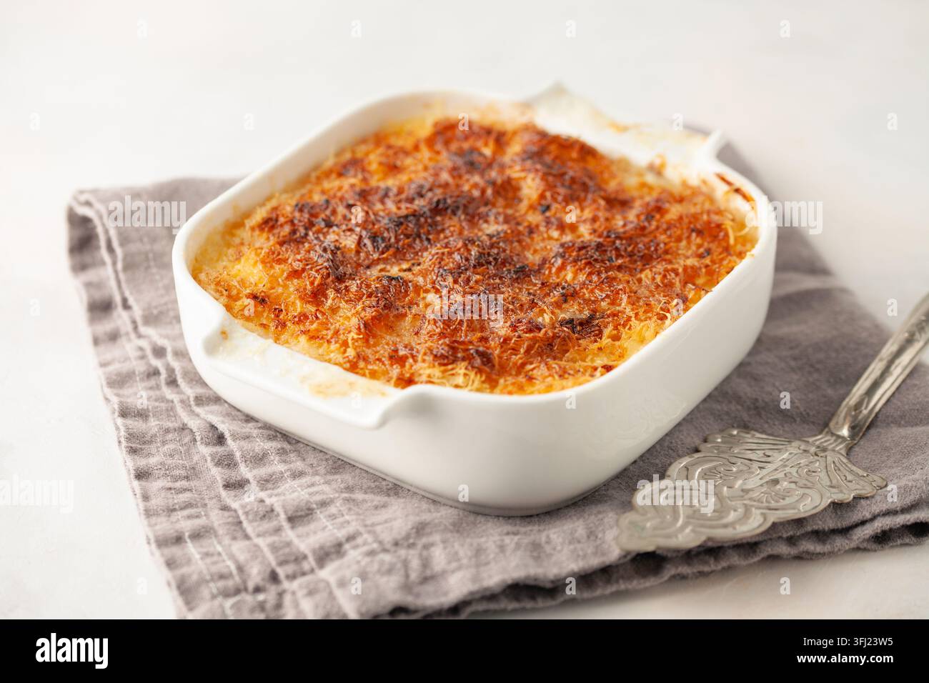 Turkish Dessert Kadayif with pistachio powder - Burma kadayif lose up view of delicious Arabic kataifi. kadayif pastry nest cook Stock Photo