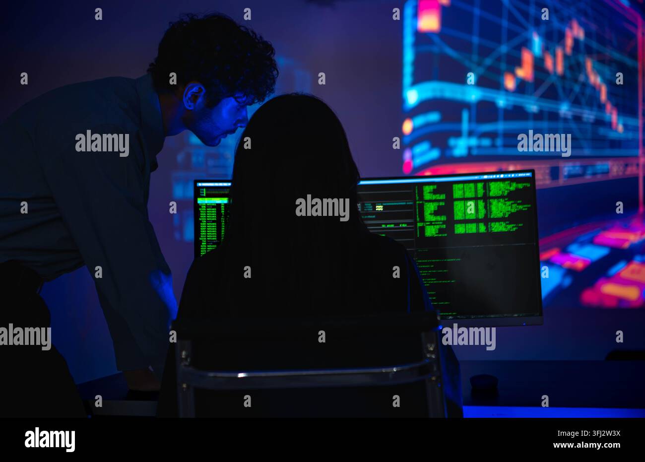 Software engineers collaborating on cybersecurity monitoring and AI powered code analysis Stock Photo
