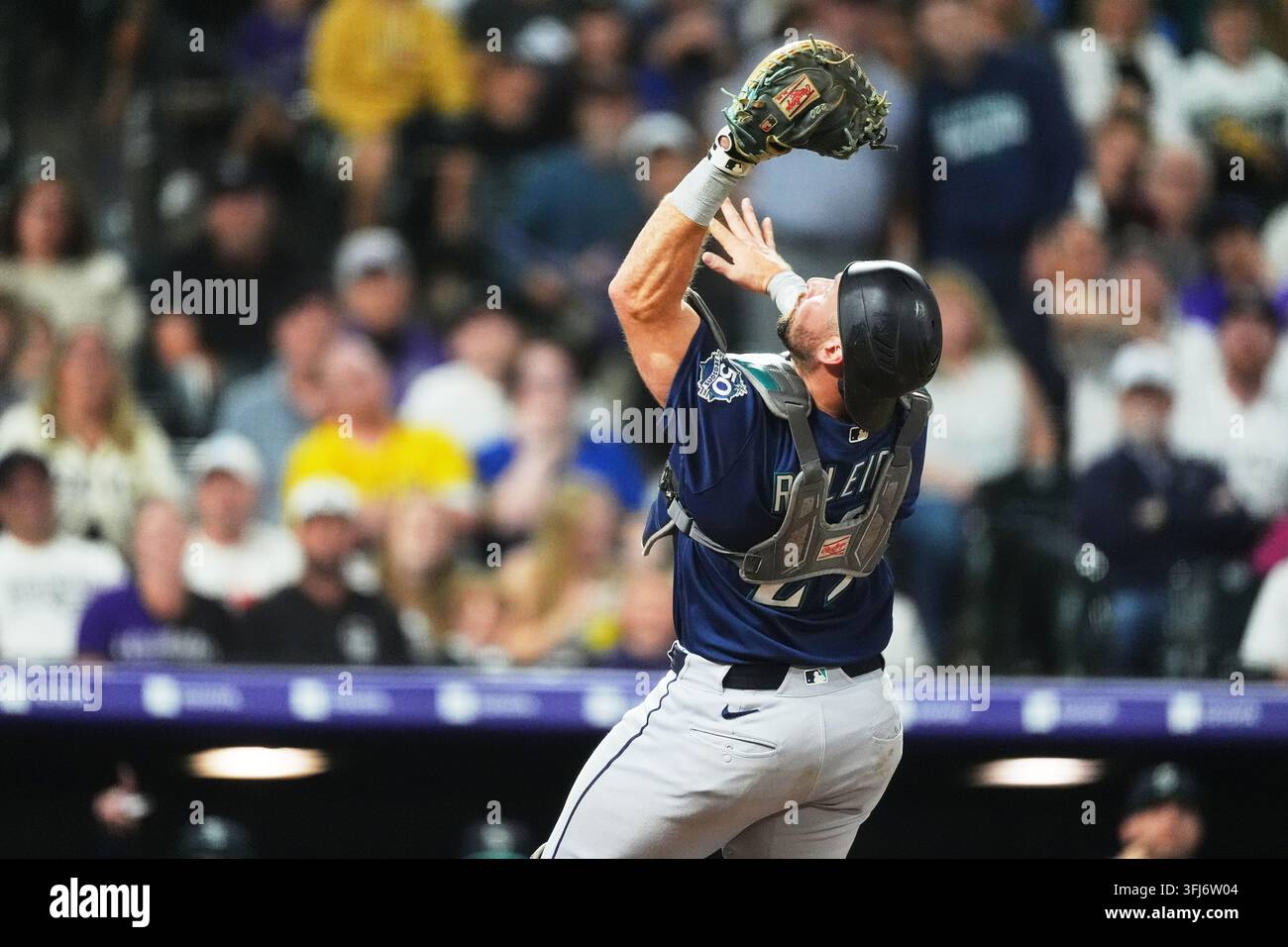 Seattle Mariners catcher Cal Raleigh pulls in a pop foul off the bat of ...