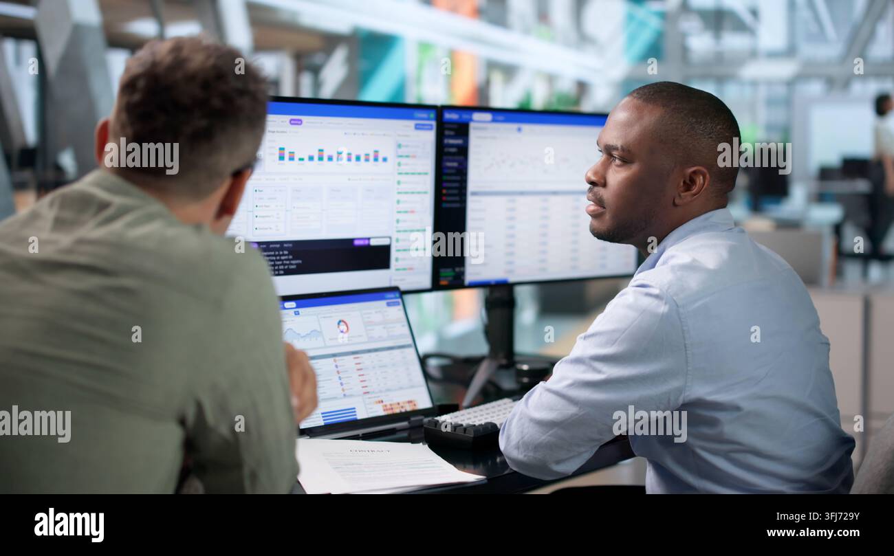 DevOps Engineer Monitors Continuous Delivery Pipeline Status Using Laptop. Stock Photo