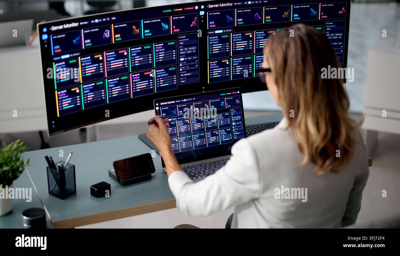IT Manager Reviews Real-time Network Data To Ensure Stable Performance. Stock Photo