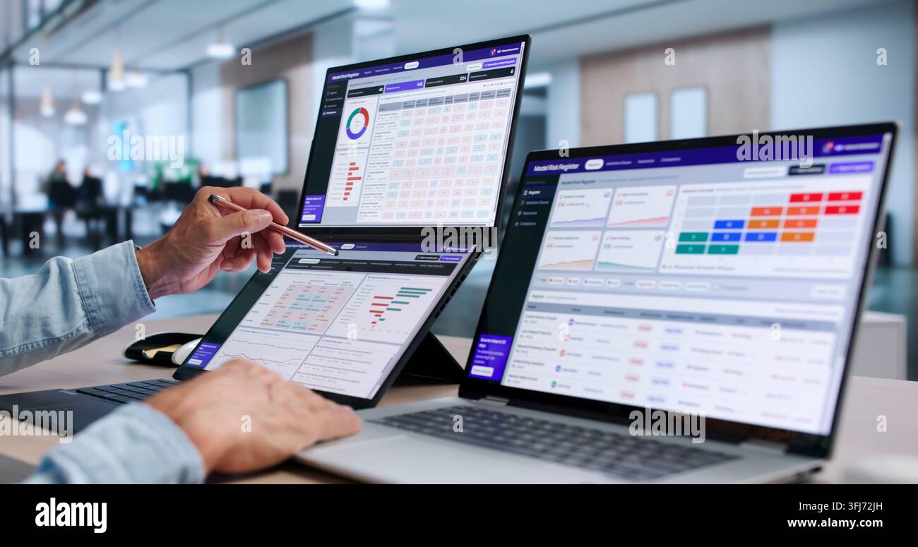 Data Scientist Carefully Monitors AI Risk With Dual Touchscreen Laptops. Stock Photo