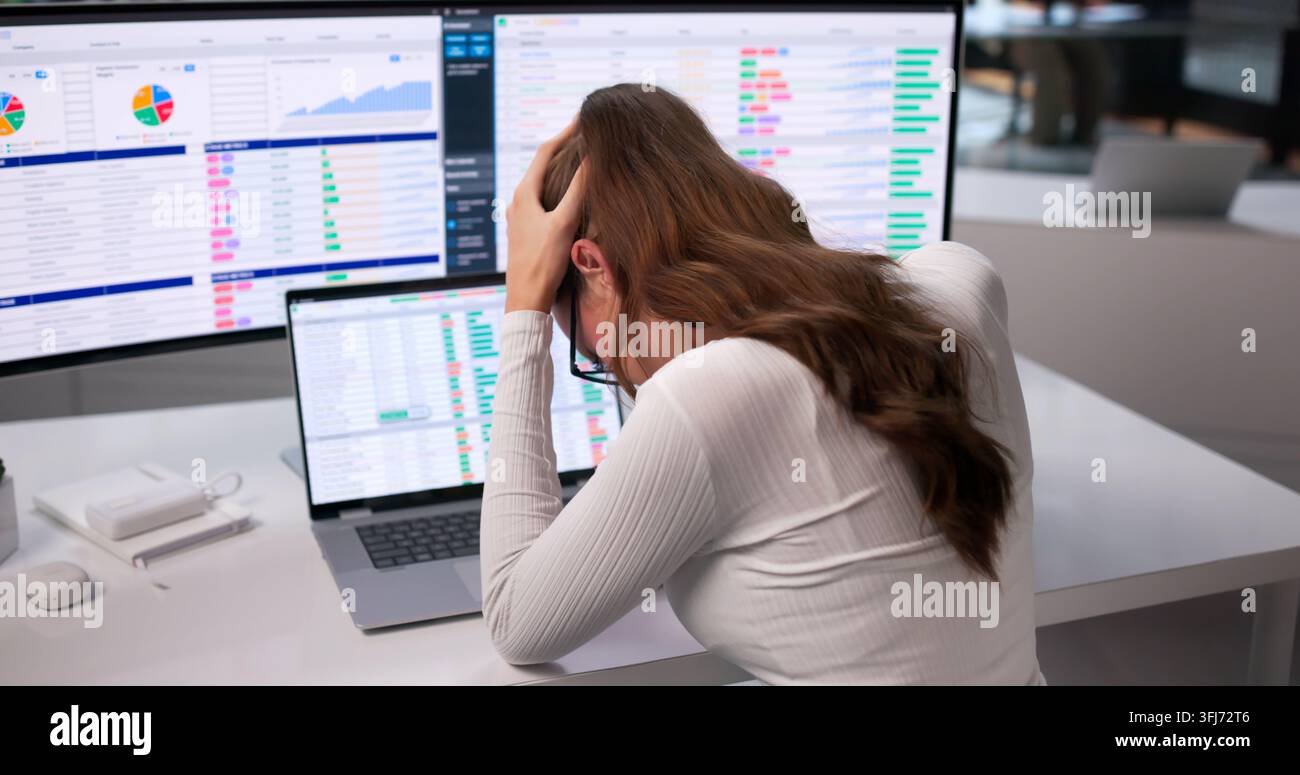 Young Business Analyst Feeling Headache While Coding Reports On Her Laptop. Stock Photo