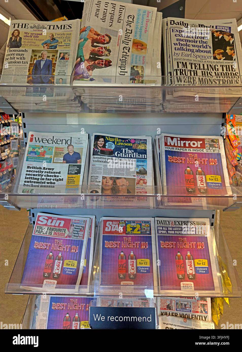Despite smartphone apps, British newspapers displayed for sale in a supermarket, including The Times, i weekend, The Guardian, Mirror and The Sun. Stock Photo
