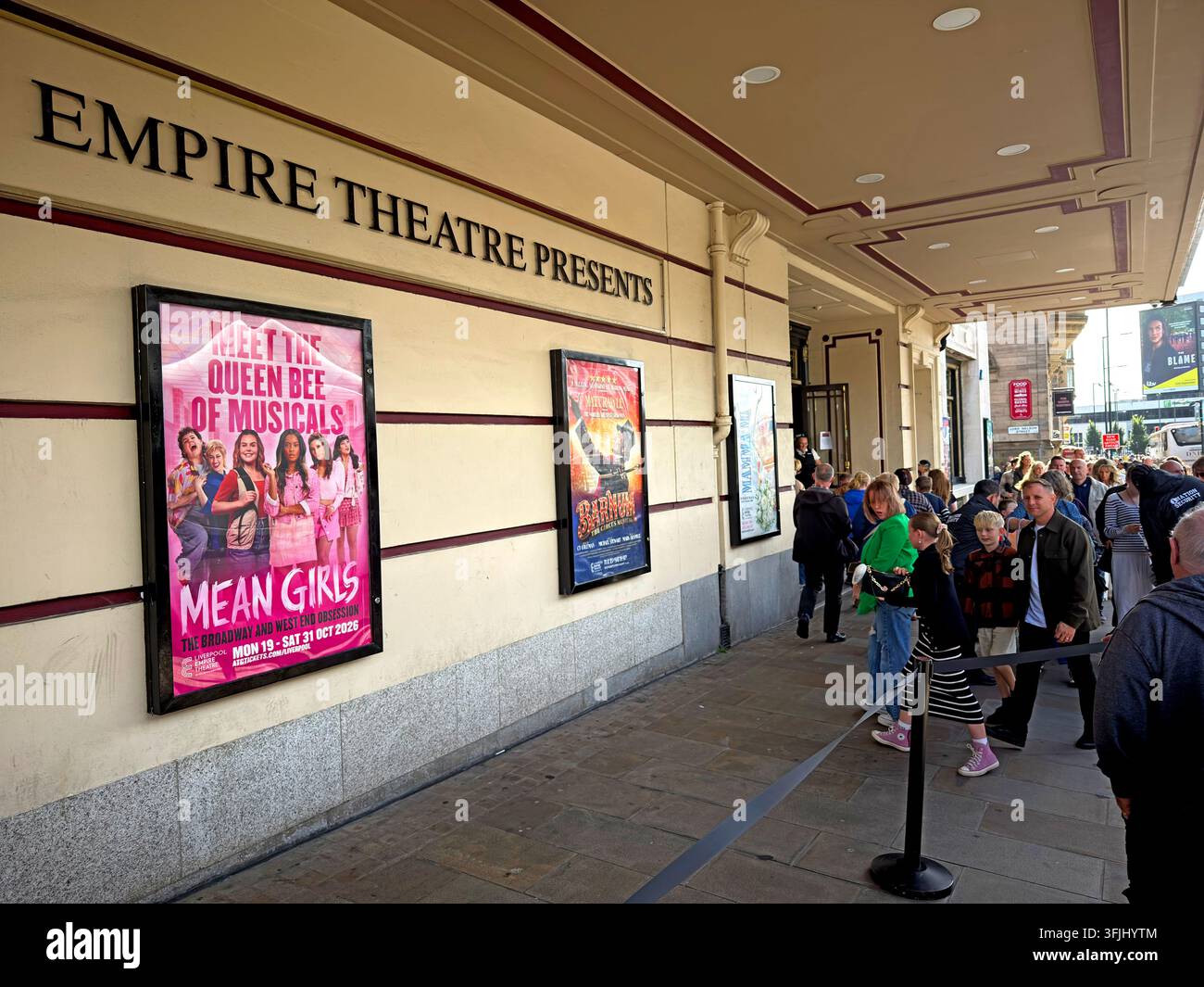 Audience queue outside Liverpool Empire Theatre on Lime Street for a performance of Mean Girls the musical. Stock Photo