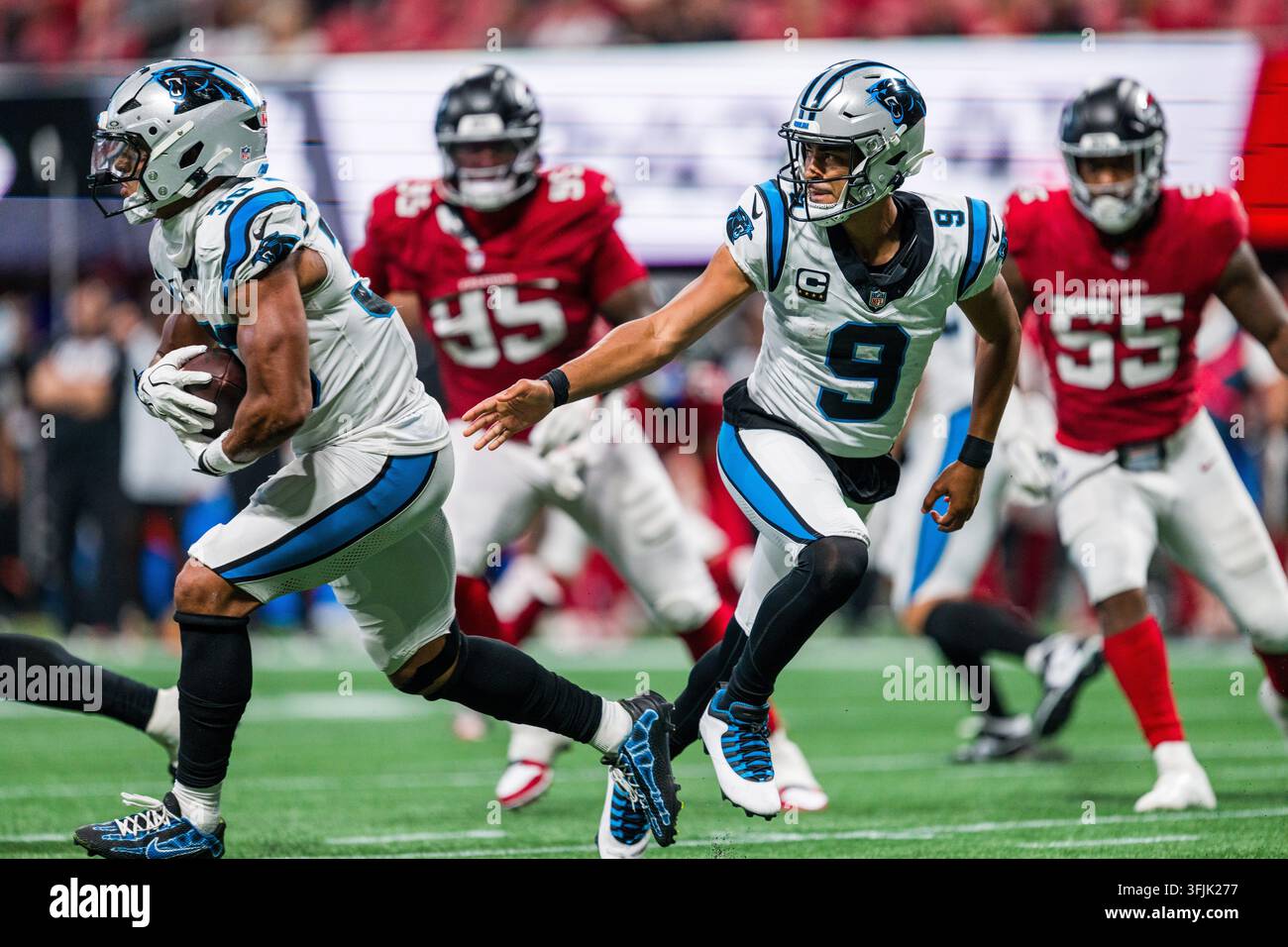 Carolina Panthers quarterback Bryce Young (9) hands off to running back ...