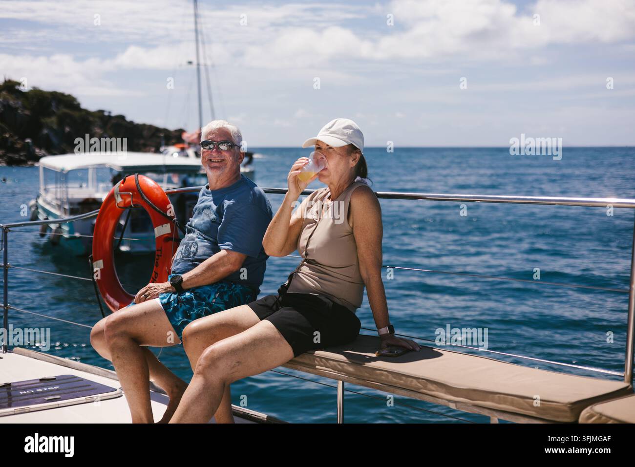 Happy mature couple enjoying a sunny boat tour Stock Photo