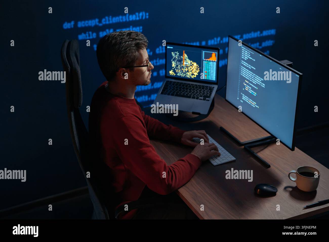 Concentrated data scientist typing code in a dimly lit workspace, multiple screens filled with programming code and data. Focused developer works late at night on a machine learning and ai project.  Stock Photo