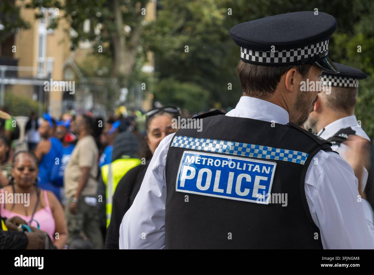 British police officer patrolling outdoor public event Stock Photo
