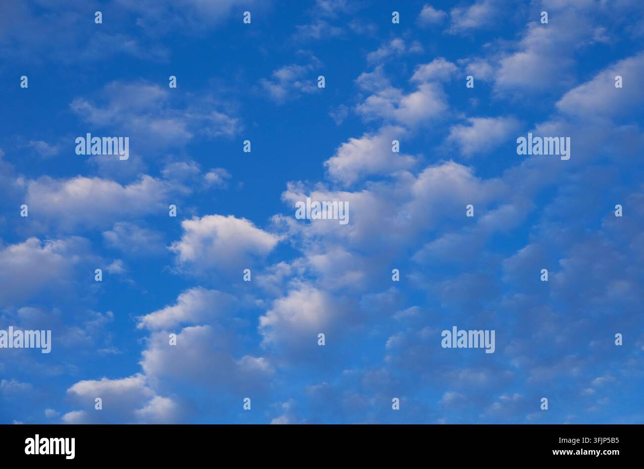 white fluffy cumulus clouds on blue sky background Stock Photo