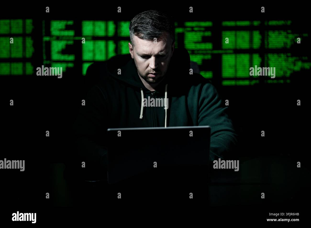 Network security specialist uses laptop. Network security specialist monitors cyber attack. Network security specialist analyzes code screen. Network Stock Photo