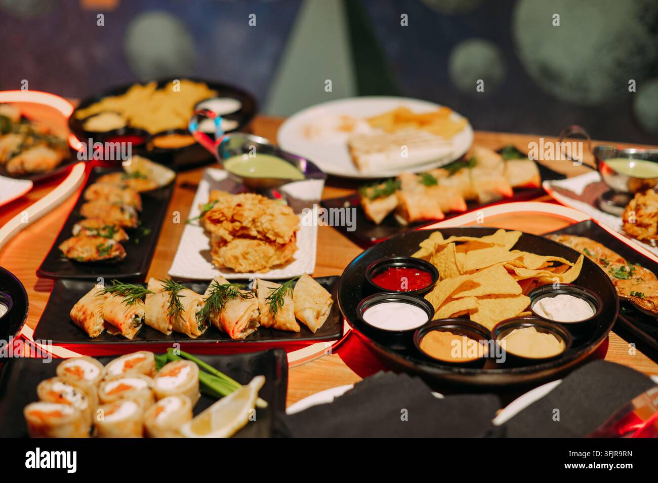 Assorted appetizers and dipping sauces served on a restaurant table Stock Photo